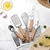 Set De Utensilios De Cocina 9 Piezas Mango De Madera Y Acero Inoxidable (S) - Tecno Importaciones