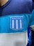 Buzo de Racing tricolor con el escudo del club bordado en el pecho.