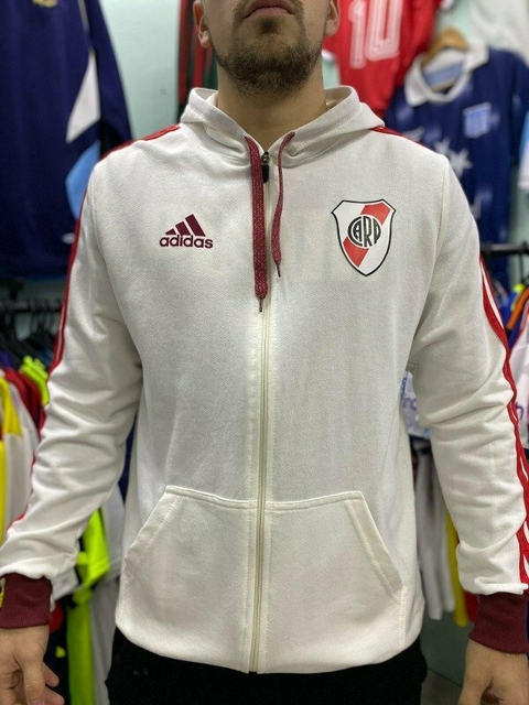Campera blanca de River Plate con detalles en rojo y logo del club, modelo de algodón.