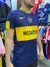 Camiseta retro de Boca Juniors 2007, con diseño azul y amarillo, mostrando el logo del club y el patrocinador "MEGATONE".