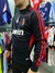 Buzo retro del AC Milan 2006, de color negro con detalles en rojo y logo de la marca.