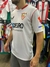 Camiseta blanca del Sevilla FC con el logo del club y patrocinadores en las mangas, modelo titular.