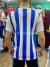 Camiseta retro de fútbol Rosamonte con rayas verticales azules y blancas vista desde atrás.