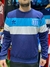 Buzo de Racing tricolor con franjas en azul y gris, modelo de Adidas.