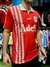 Camiseta roja de Independiente con diseño de rombos y logo de Adidas, modelo 1995.