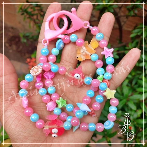 Prendedor de Chupetas Rosa e Azul Tema Praia Ibejada de Umbanda e Candomblé Ateliê Biju dos Orixás