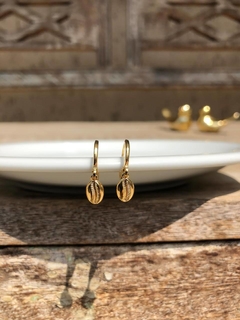 Brinco de argolinha Coleção AL MARE com pingente de búzio, banhado em ouro 18k.