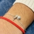 Pulsera con bolita y sol colgantes - comprar online