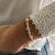 PULSERA PLATA COLA DE RATA DE BOLAS LISAS FLOR CENTRAL Y DONAS - comprar online