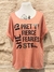 Remera de mujer color durazno con un diseño que incluye la frase "SHE IS PRETTY FIERCE FEARLESS STRONG" en letras negras y brillantes.