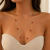 Colar Longo Feminino em Aço Inoxidável Dourado com Trevos Vermelho Preto Branco – Colar Elegante Antialérgico Premium na internet