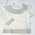 Buzo Blanco Jaspeado y gris en internet