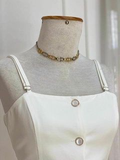 Detalhe da blusa branca do conjunto Taís, com alças e botão em destaque.