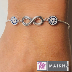 Pulsera Infinito en Plata lisa con círculos pave en los laterales cristal y azul