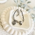 Pulsera torneada con dijes hamsa y corazon