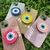 Capa com brilho + suporte olho grego iPhone 13