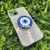 Capa com brilho + suporte olho grego iPhone 13 - comprar online