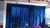 Cortina em tecido rústico azul marinho para varão modelo ilhós.