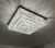 Lustre plafon quadrado transparente da Linha Cristal Harion, com acabamento brilhante e detalhes em cristal.