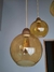 Luminárias pendentes da linha Sarvah com cúpulas de vidro âmbar.