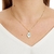 Colar com pingente mão grega cravejada com zircônias folheado a ouro 18k - comprar online