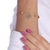 PULSEIRA COM PINGENTE EU AMO PRAIA E ZIRCÔNIA FOLHEADO A OURO 18K - comprar online