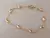 PULSERA DE ACERO DORADO ESPEJITO CON BOLITAS OVALADAS. LARGO 19 CM