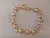 PULSERA DE ACERO DORADO ESLABÓN ROLO CONECTADO CON ARGOLLA. LARGO 18,5 CM