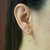 Brinco de argolinha fechada com pingente de bolinha 5mm folheado a ouro 18k