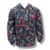 Buzo anorak de mujer en microfibra negra con diseño floral y logotipo de Yazuka.
