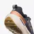 Zapatillas deportivas FILA Duality 2 para mujer en colores grafito, negro y cobre, vista trasera del calzado con suela blanca y detalles reflectantes