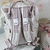 Mochila Multifuncional Offwhite com rose na internet