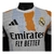 Camisa Real de Madrid Pré-jogo 25/26 - Jogador Adidas Masculina - Branca com detalhes em laranja e preto e azul - comprar online