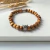 Pulseira Bolas de Madeira 6mm Raposa e Mão de Fátima - Da Caixola da Biola
