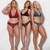 três muheres de corpos reais usando lingerie de renda