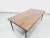 Mesa de centro com tampo em jacarandá e estrutura em ferro tubular pintado de preto. - buy online