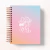 Agenda com capa em aquarela degradê em tons de azul, rosa e laranja com texto motivacional em branco