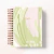 Caderno espiral com capa em tons suaves de verde e rosa, com a palavra "Dream" escrita em dourado