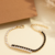 pulseira composiçao cravejada de zirconias preta e branca banhado a ouro com garantia