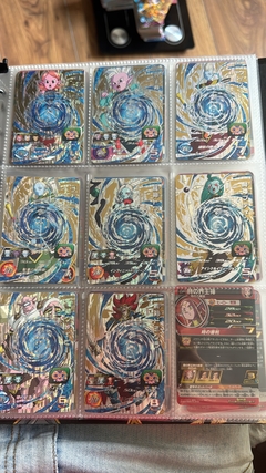 671 cartas de dragon ball héroes + 26 packs sellados Vjump + 100 slaves + binder con 25 micas