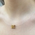 Colar Letra no Fio de Nylon Folheado a Ouro 18k.