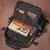 mochila para notebook preta allblack aberta sobre um fundo marrom, mostrando todos os bolsos internos e bolso com alça para armazenas notebook e livros com um grane espaço interno.