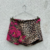 Short saia animal print CAOS na internet