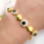 Pulseira Riviera Com Pedra Onix e Meia Esfera Banhado a Ouro