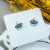 Brinco Mini Coroa Azul Safira e Zircônias Banhado a Ouro