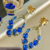 Conjunto de Brinco e Anel Cristais Azul Safira Cravejado Banhado a Ouro