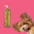 Frasco do Shampoo Liso Absoluto Rubi Cereja e Avelã da Dolce Pet ao lado de um cachorro feliz.