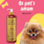 Frasco de condicionador Topázio Cereja e Avelã para cães e gatos da marca Dolce Pet, com um fundo colorido e um cachorro fofo ao lado.
