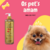 Frasco de condicionador Rubi Liso Absoluto Cereja e Avelã da Dolce Pet ao lado de um cachorro Pomeranian sorridente.
