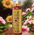 Frasco de Shampoo Clareador Tonalizante Ametista Cereja e Avelã 500 ml da Dolce Pet, com flores ao fundo.